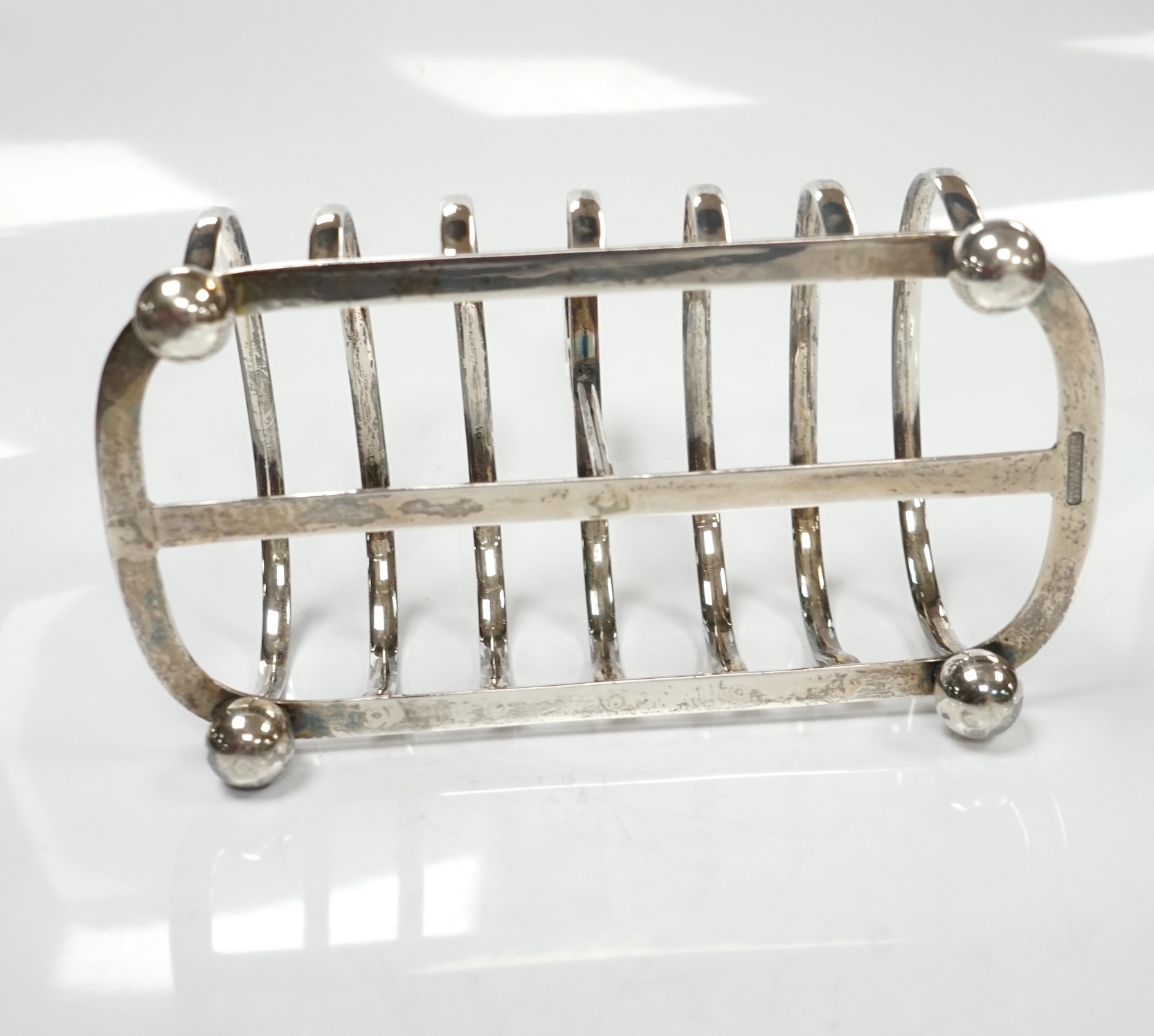 A George V silver seven bar toast rack, by Mappin & Webb, Sheffield, 1913, length 15cm, 7.3oz. Condition - fair to good